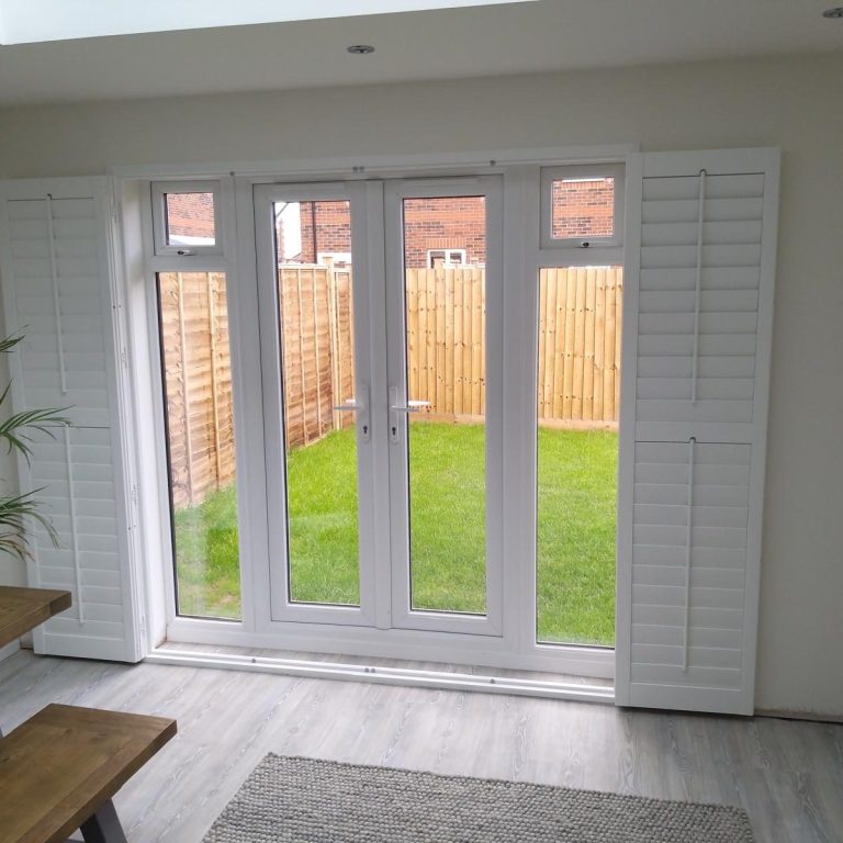 Full-height wooden plantation shutters in contemporary Telford bedroom | Custom supply & install West Midlands Full-height wooden plantation shutters in contemporary Telford bedroom | Custom supply & install West Midlands