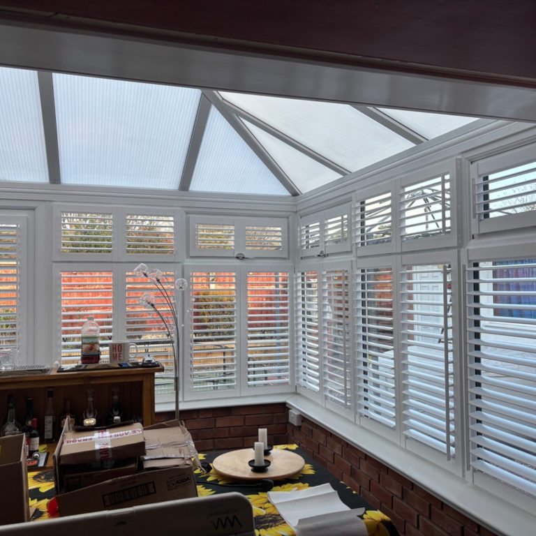 Perfect Fit Shutters Conservatory High Ercall Frameless perfect fit plantation shutters in bright High Ercall conservatory | Energy-efficient light control by Shutters Emporium Telford
